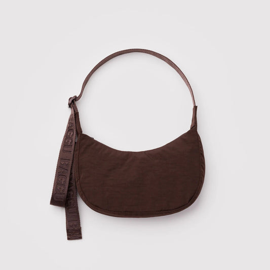 Brown shoulder bag with a strap on a light gray background