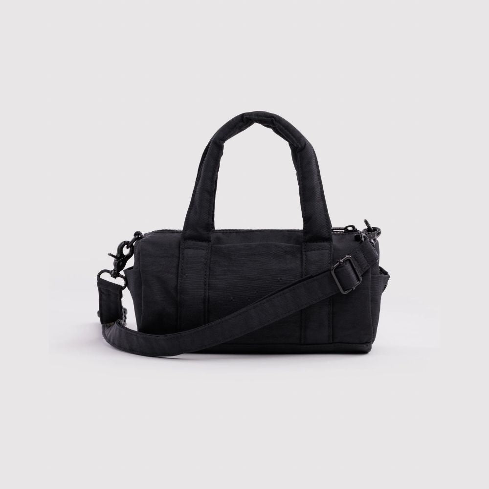 A black nylon duffel bag with dual top handles and an adjustable shoulder strap, shown against a plain white background.