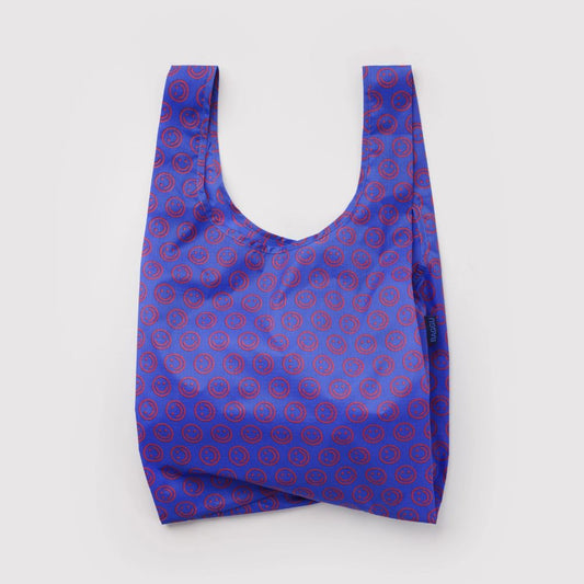 A reusable tote bag with a blue and red repeating circular pattern, photographed flat against a light gray background.
