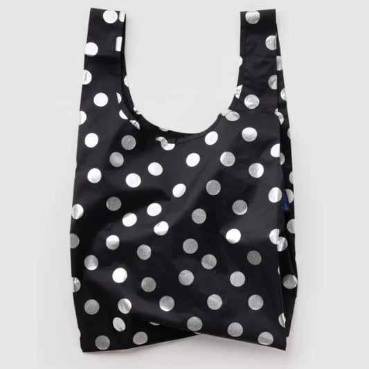 A reusable black plastic shopping bag with a shiny silver polka dot pattern, shown against a plain light gray background.