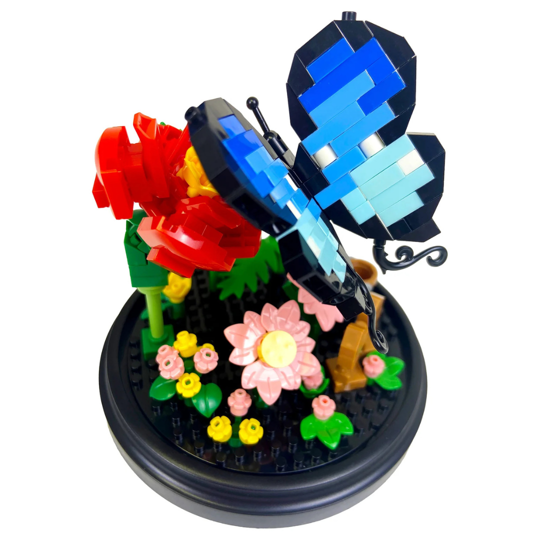 Toy block butterfly and flowers on a round base with a white background