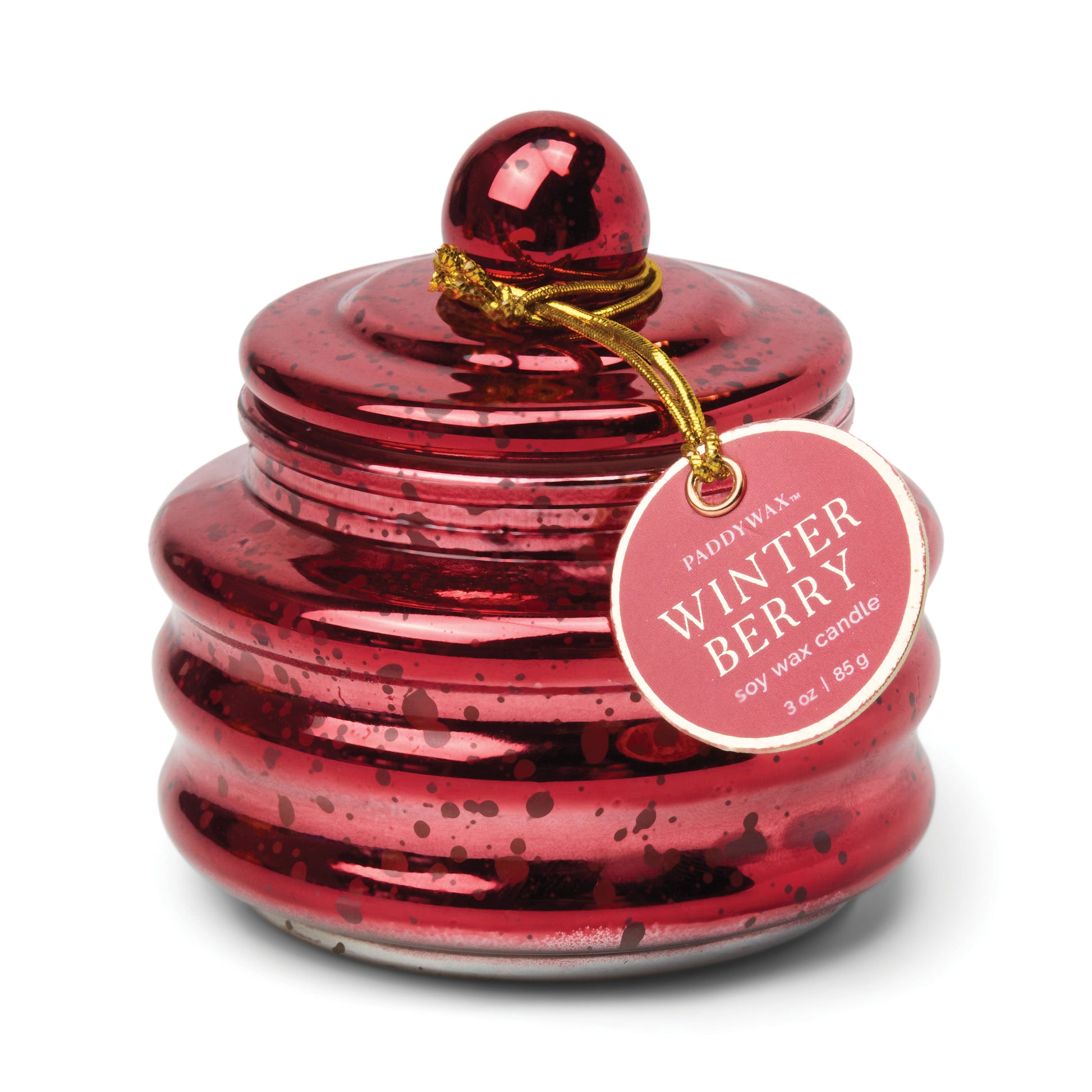 Candle in a red mercury glass lidded vessel tag says "Paddywax Winter Berry soy wax candle"