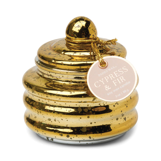 Candle in a lidded gold mercery glass vessel. Tag reads "Paddywa Cypress & Fir Soy Wax Candle"