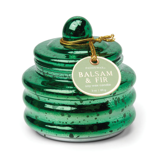 Candle in a lidded green mercury glass vessel. Tag reads "Paddywax Balsam & Fir Soy Wax Candle"
