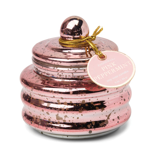 Candle in a lidded pink mercury glass vessel. Tag reads "Paddywax Pink Peppermint Soy Wax Candles"