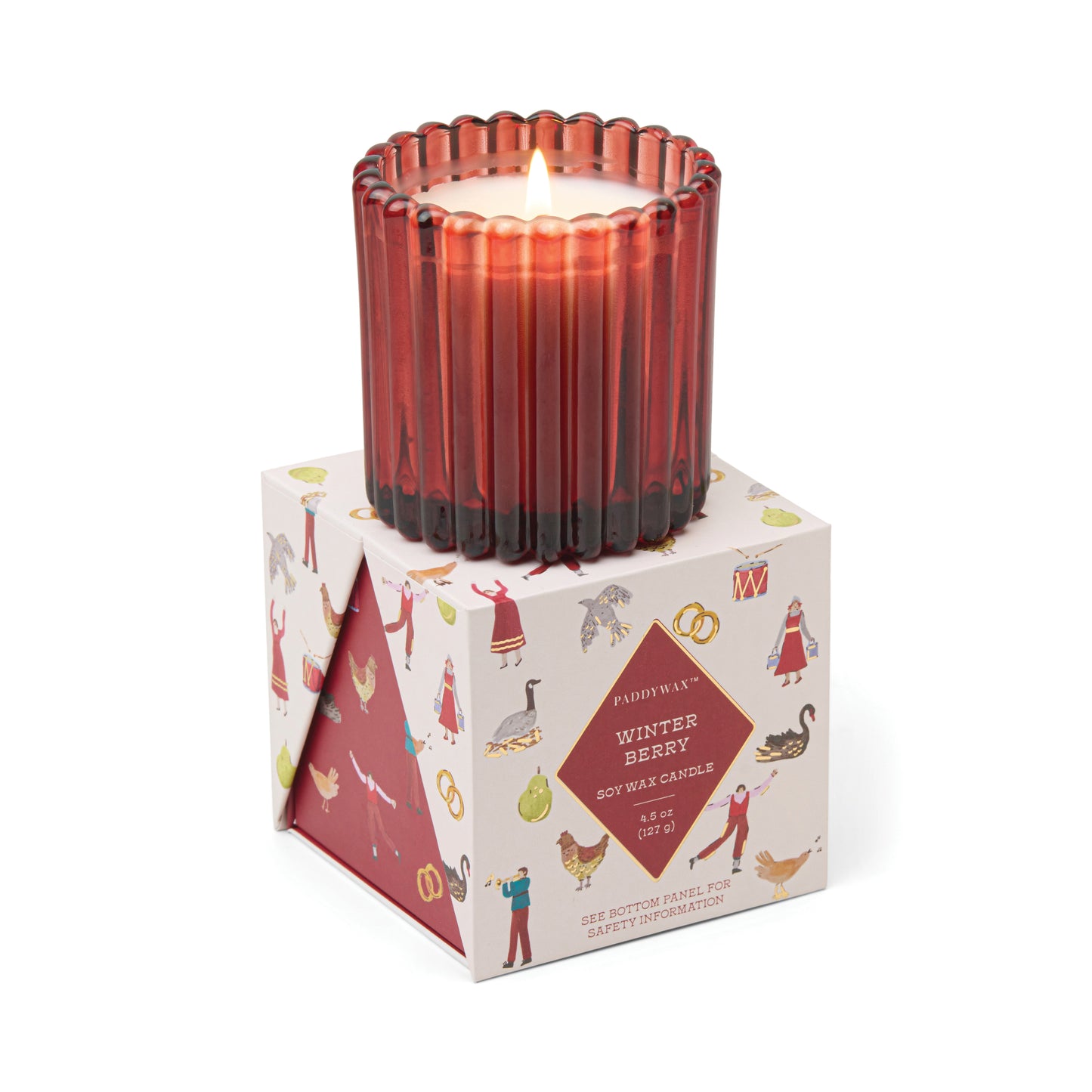 Candle in a fluted red glass container atop a presentation box decorated with the 12 days of Christmas. Label reads "Paddywax Winter Berry Soy Wa Candle"