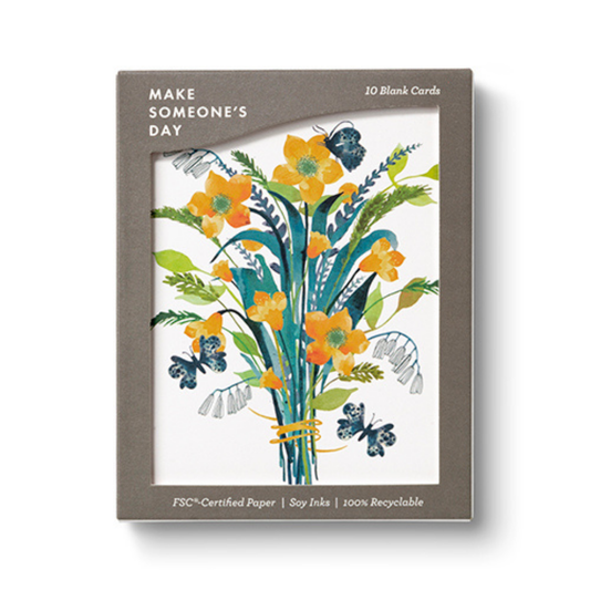 Brown box with a large open window displaying the cards.  The cards are white and feature a bouquet of orange and yellow flowers with blue and green foliage and butterflies floating about. The box says "Make Someone's Day" in the upper right hand corner and "10 Blank Cards" in the upper left. Along the bottom it says "FSC Certified Paper|Soy Ink|100% Recyclable"