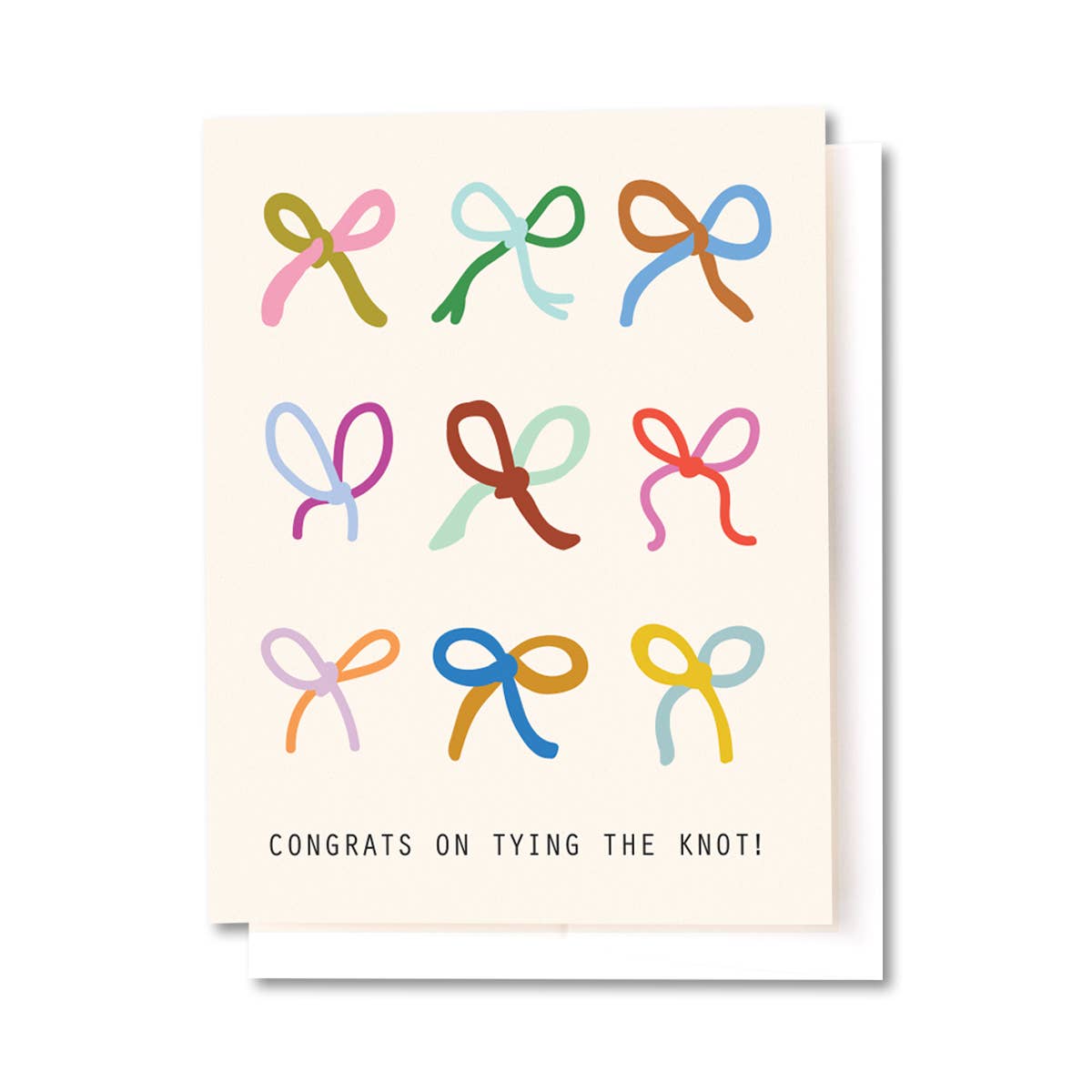A greeting card with a cream background featuring nine colorful ribbon-bow illustrations in different hues and the text 'CONGRATS ON TYING THE KNOT!' at the bottom. A white envelope is partially visible behind the card.