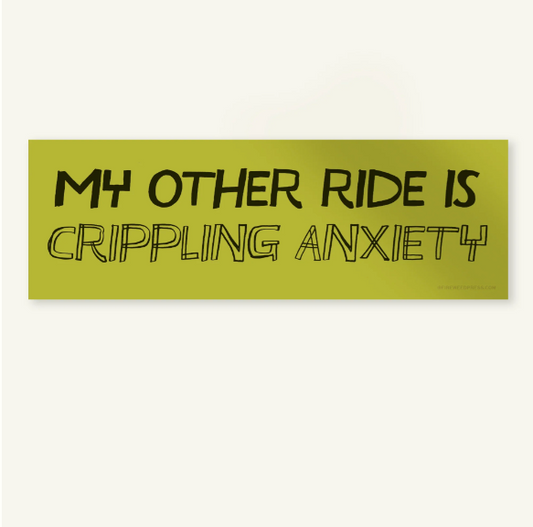 A rectangular bumper sticker with a muted olive green background and black text that reads 'MY OTHER RIDE IS CRIPPLING ANXIETY' in a hand-drawn outline font, shown against a plain off-white background.