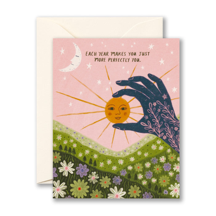 Birthday Card featuring a smiling son and sleeping moon over a field, a hand "holds" the sun. "Each year makes you just more perfectly you."