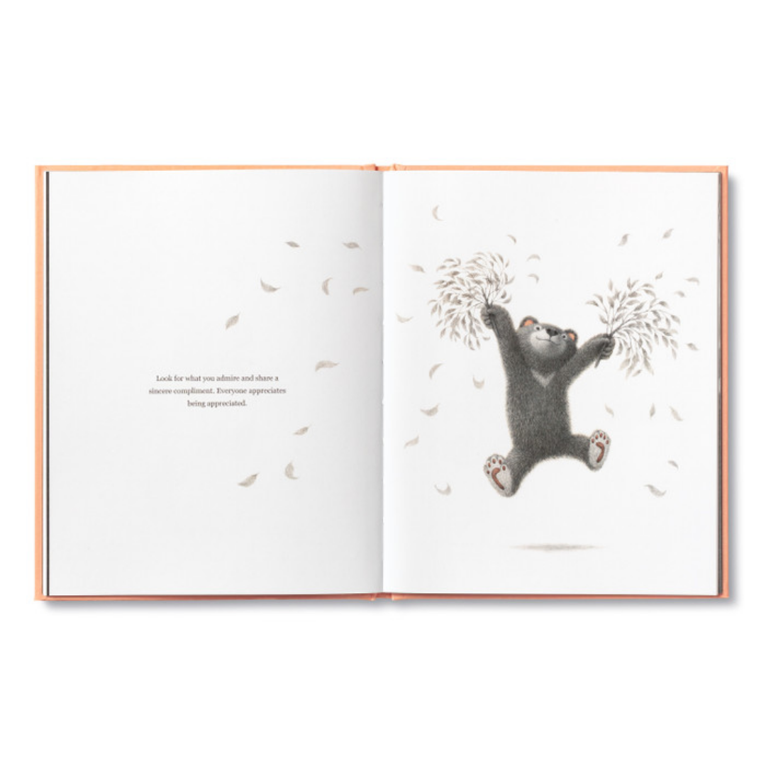 Page from "Being Kind"- the bear cub jumps using a pair of leaf covered branches as pom poms, the leaves flying from them like firework sparklers