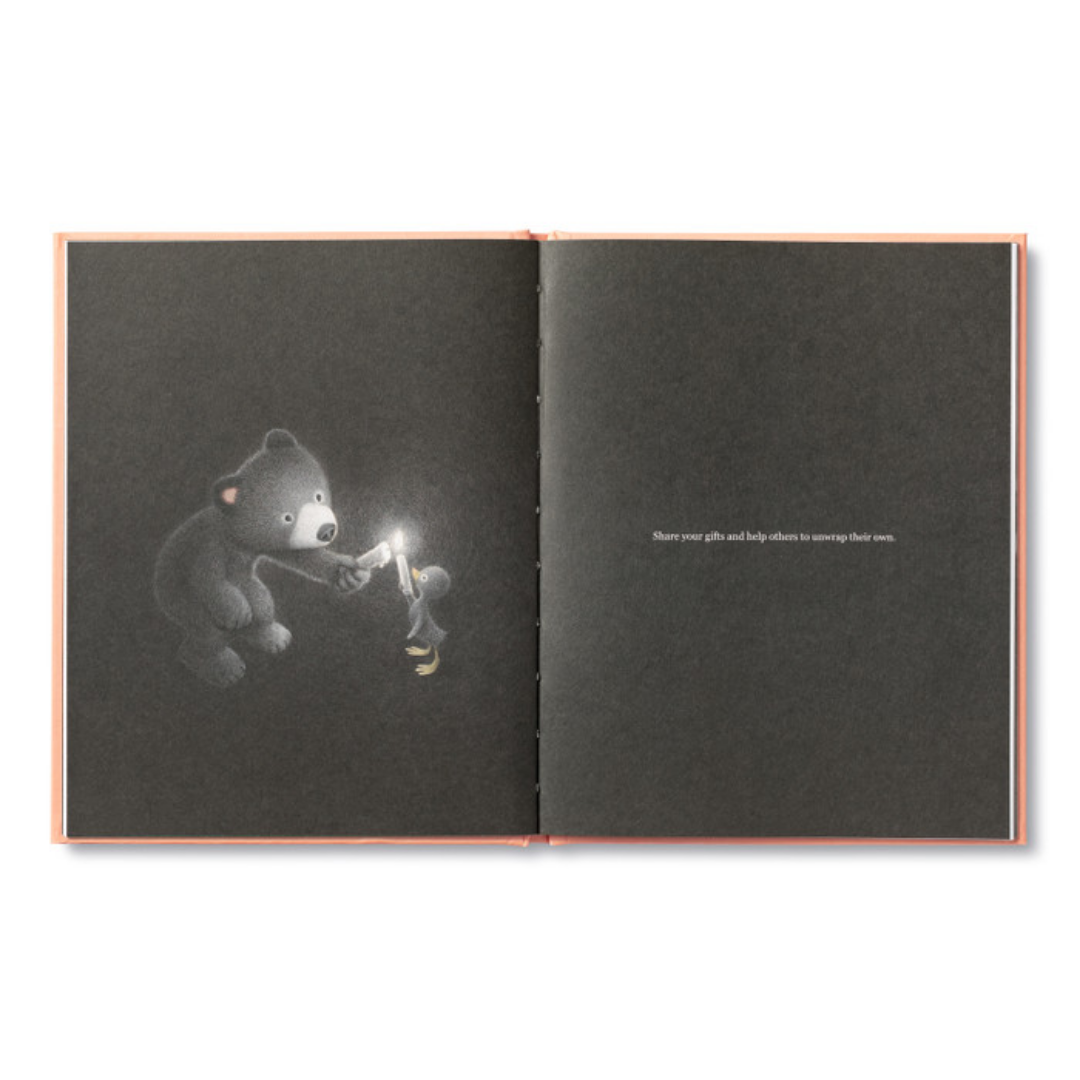 Page from "Being Kind"- the bear and a duckling are in the dark, the bear is using a lit candle to light the duckling's candle