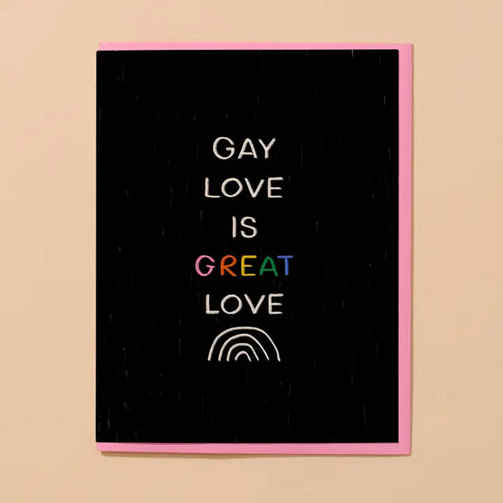 Card with 'Gay Love is Great Love' text and rainbow symbol on a black background with pink border.