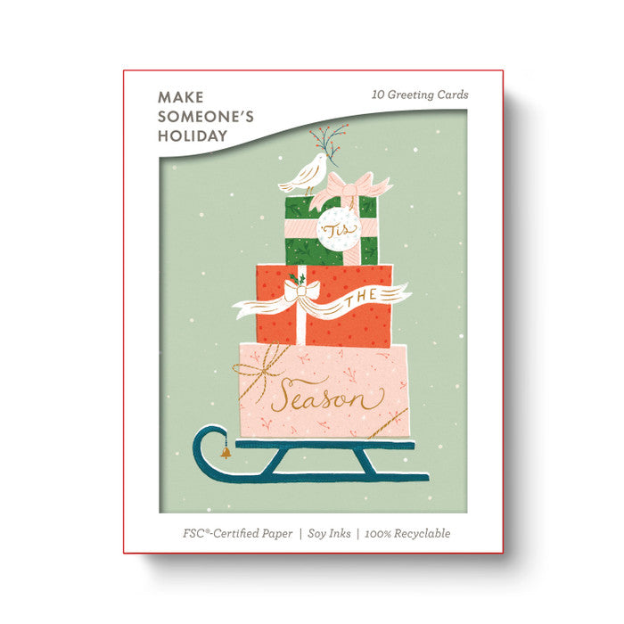 Packaging of 'Make Someone's Holiday' greeting cards with Christmas-themed design.