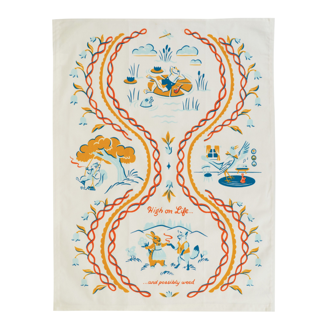 A tea towel featuring a bunch of animals living their best lives. A frog with a pipe relaxes on a lily pad, a squirrel smokes while on a tree swing, a bird listens to records with a bong, and a rabbit and fox smoke and collect flowers. The towel reads "High on life... and possibly weed."