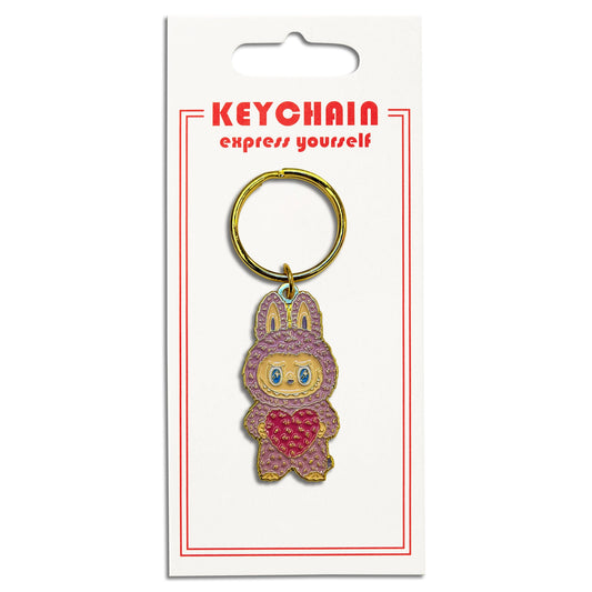Keychain with cartoon character holding a heart on a white card.