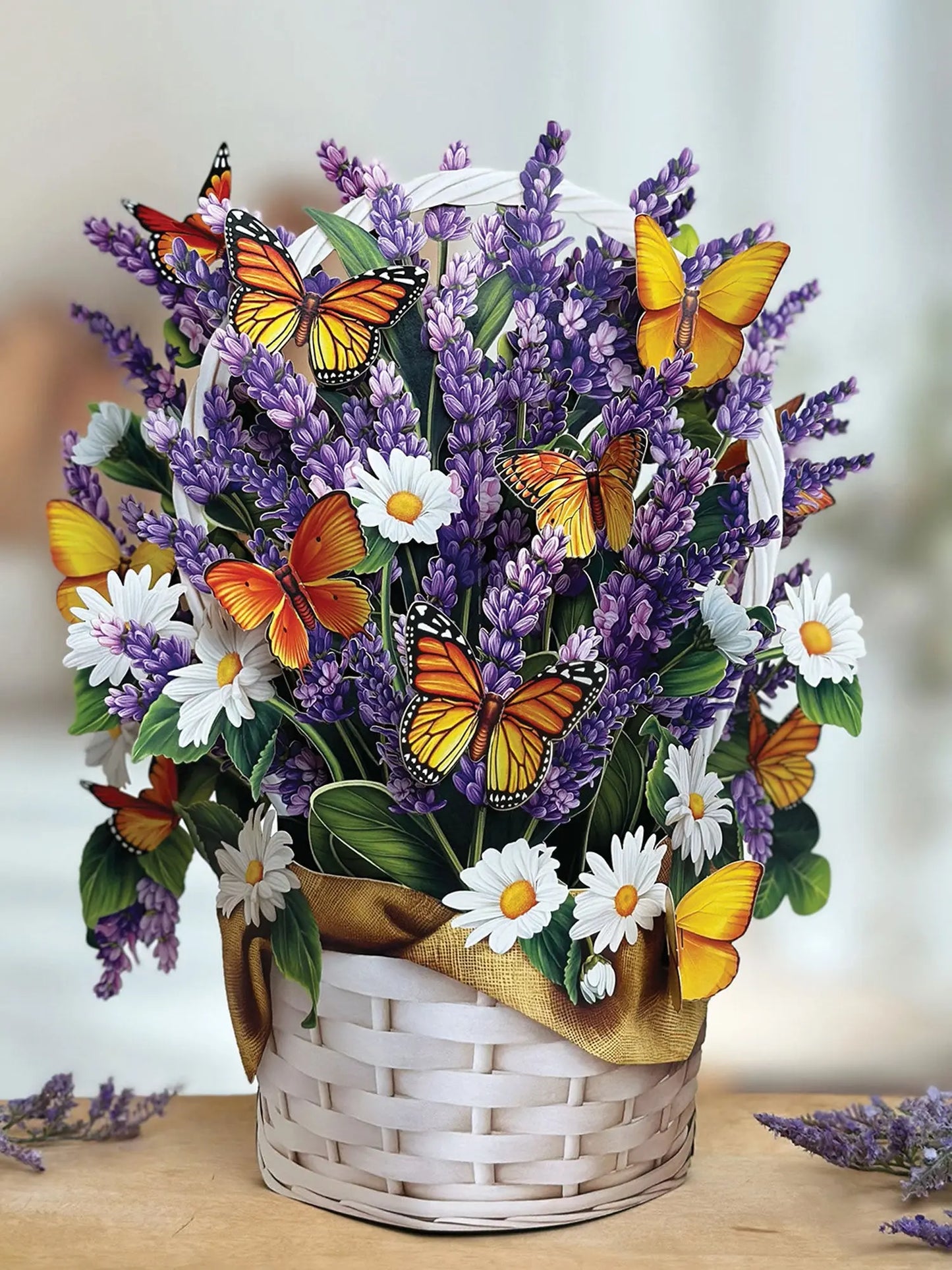 Pop up card that looks like a white woven basket full of daisies and lavender with butterflies flitting around