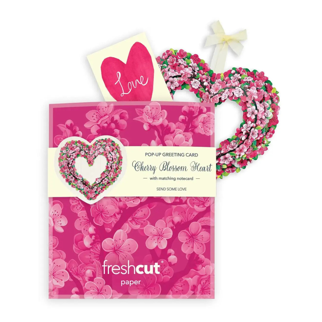 Floral heart-shaped pop-up greeting card with matching envelope and decorative ribbon on a white background.
