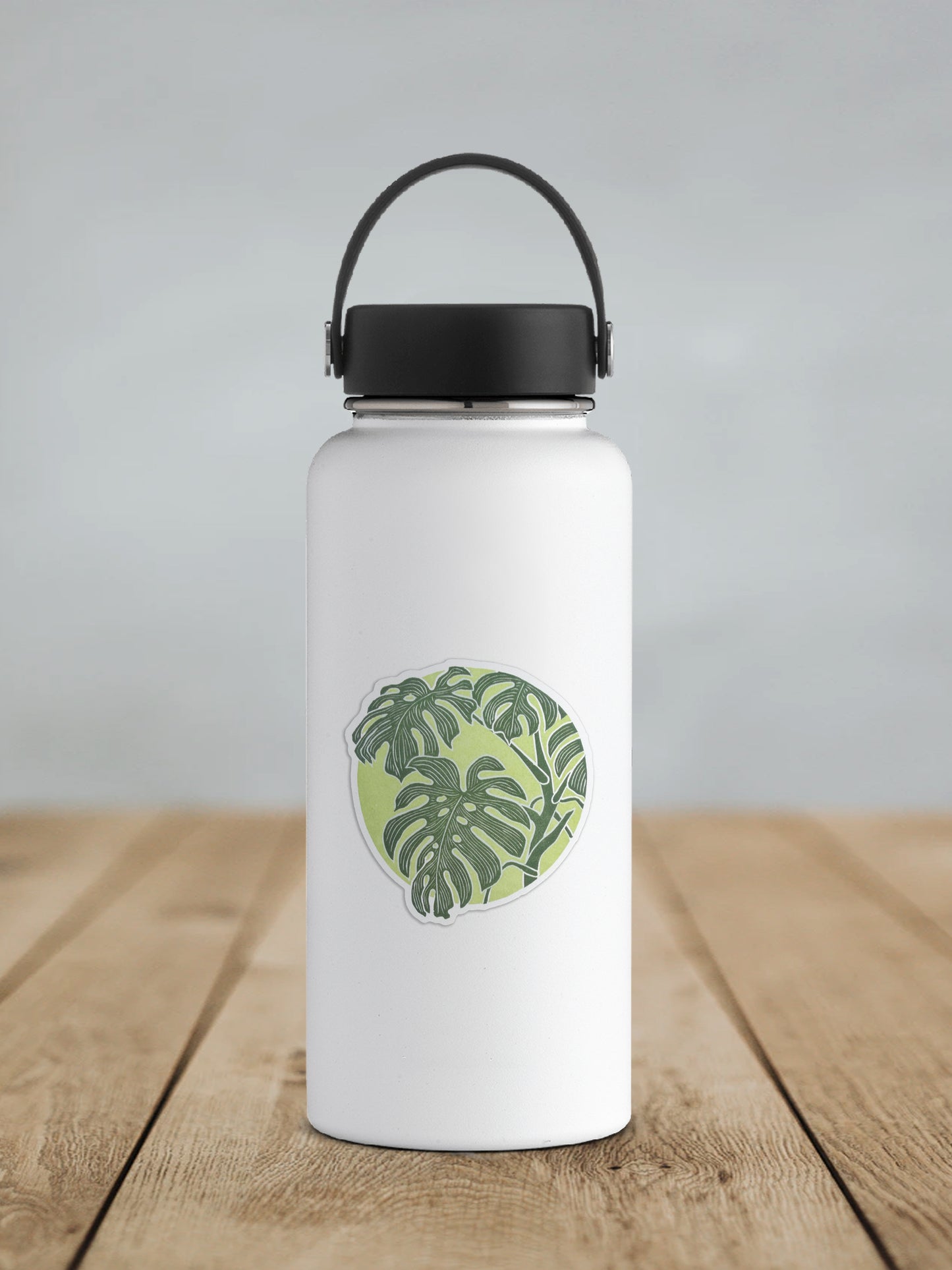 Monstera Leaf sticker featuring a two tones green design on a white water bottle.