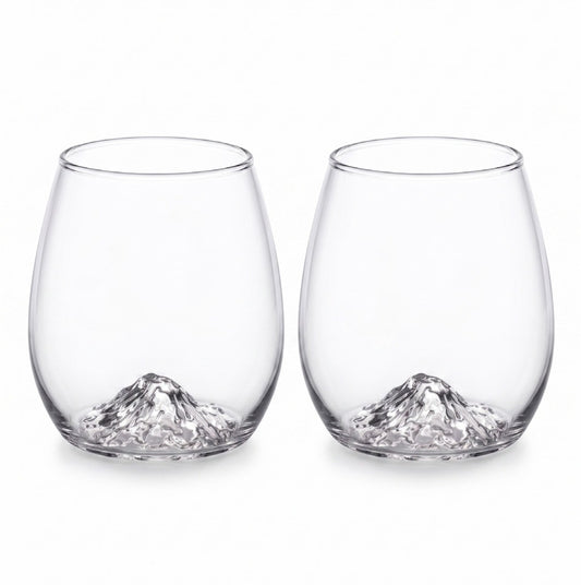Two clear stemless wine glasses with a sculpted mountain design at the base, shown side by side on a white background.