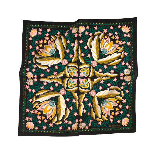 A square scarf with a black border and a highly detailed, symmetrical floral pattern in gold, pink, green, and white, displayed flat against a solid white background.