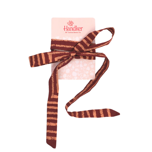 Handker's Sammi Pink Bowie Tie wrapped around it's presentation card. Tie is pink and maroon, rustic stripes.
