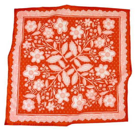 Floral patterned bandana with red border on a white background