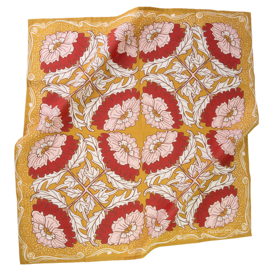 A square cotton scarf with a vintage floral pattern, featuring red and light pink flowers with white leaves on a mustard yellow background. 