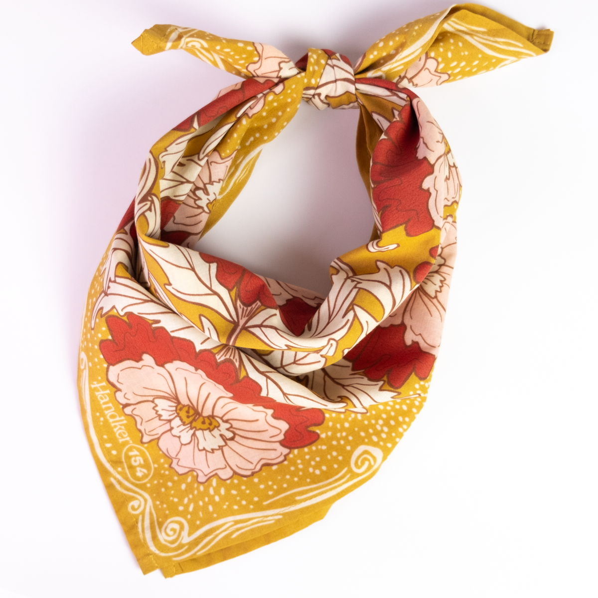Floral patterned bandana with yellow border on a white background