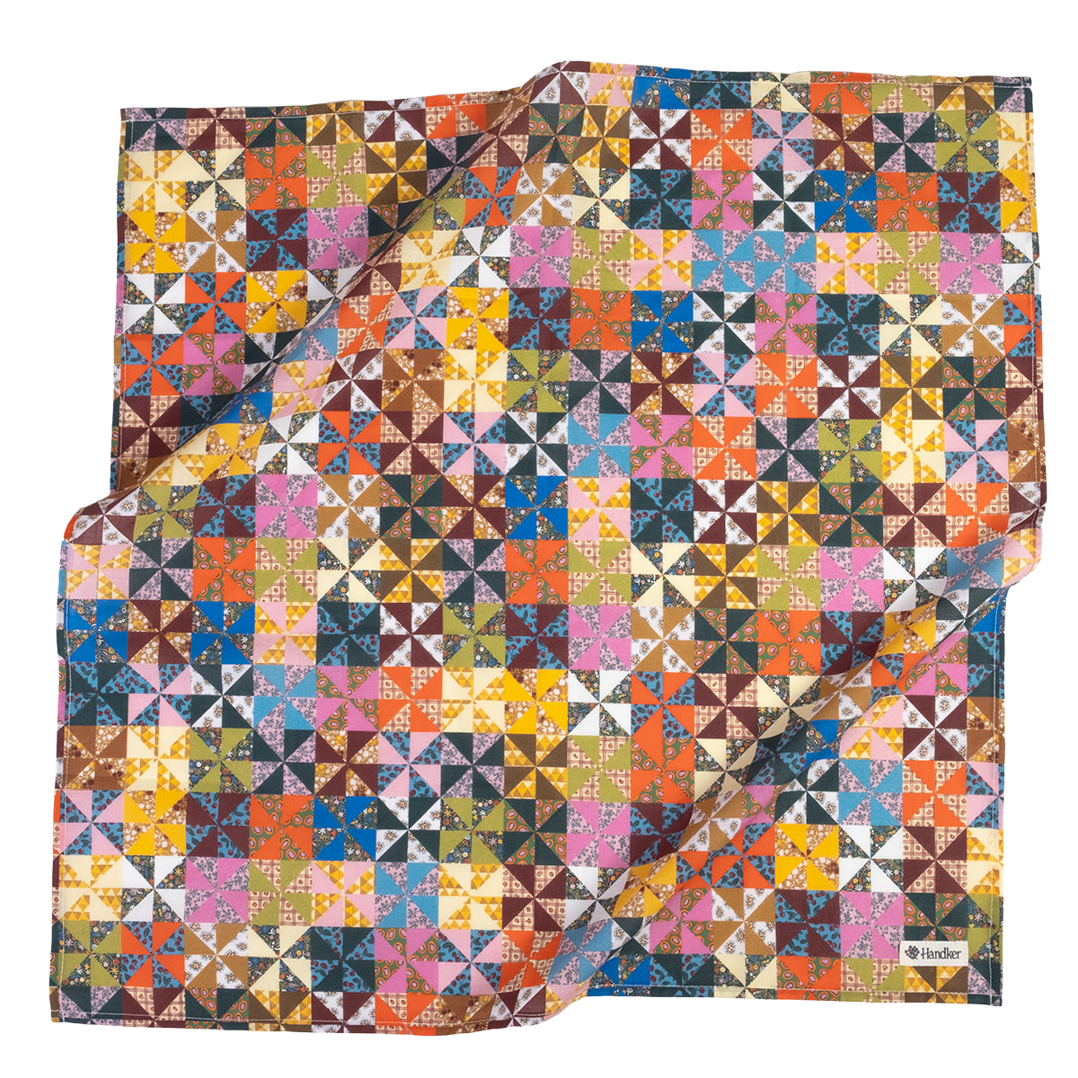 A square scarf featuring a colorful geometric patchwork pattern of triangles and squares in many shades, including pink, blue, yellow, orange, brown, green, and white. 