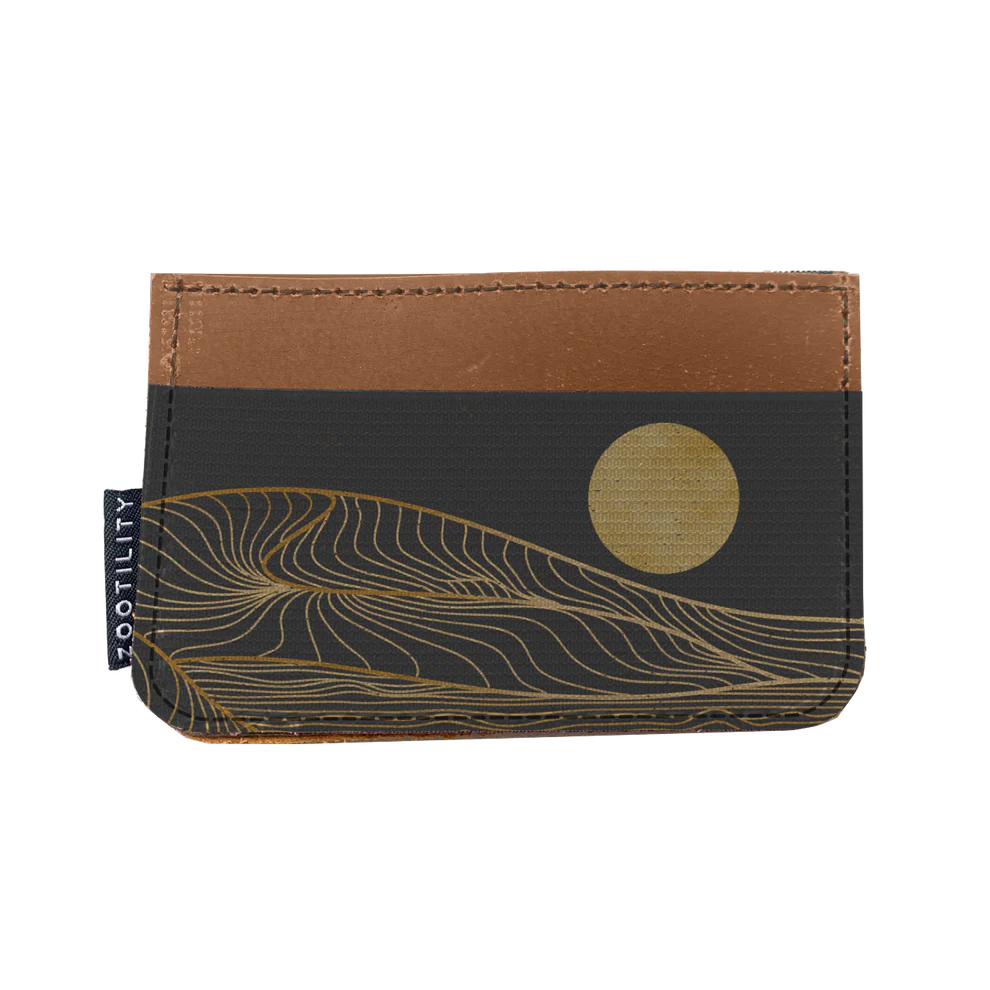 Slim leather wallet with an elastic pocket illustrated with a black dune design