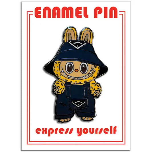 Enamel pin with a character wearing a hat and overalls on a white background with red text.
