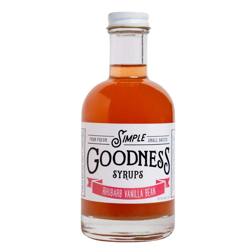 Bottle of Simple Goodness Syrups with rhubarb vanilla bean. Syrup is a rich orange/pink color