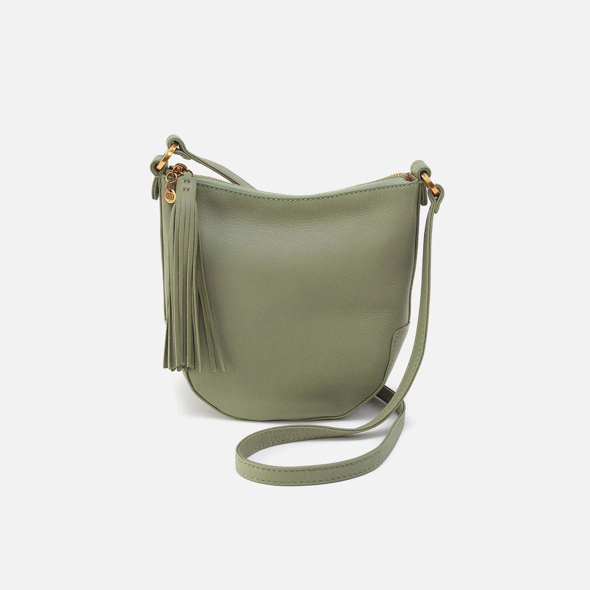 Lexi crossbody bag is a rich sage green leather with a shoulder strap and leather tassel.