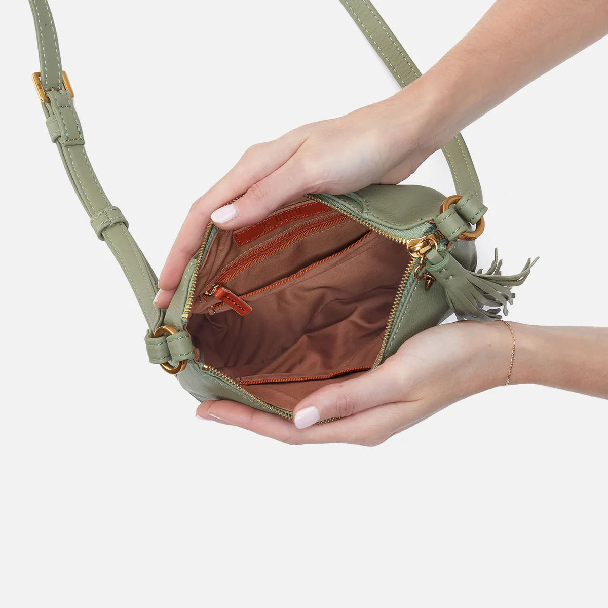 Inside of the bag is a rich brown with 2 pockets, one with a zipper.