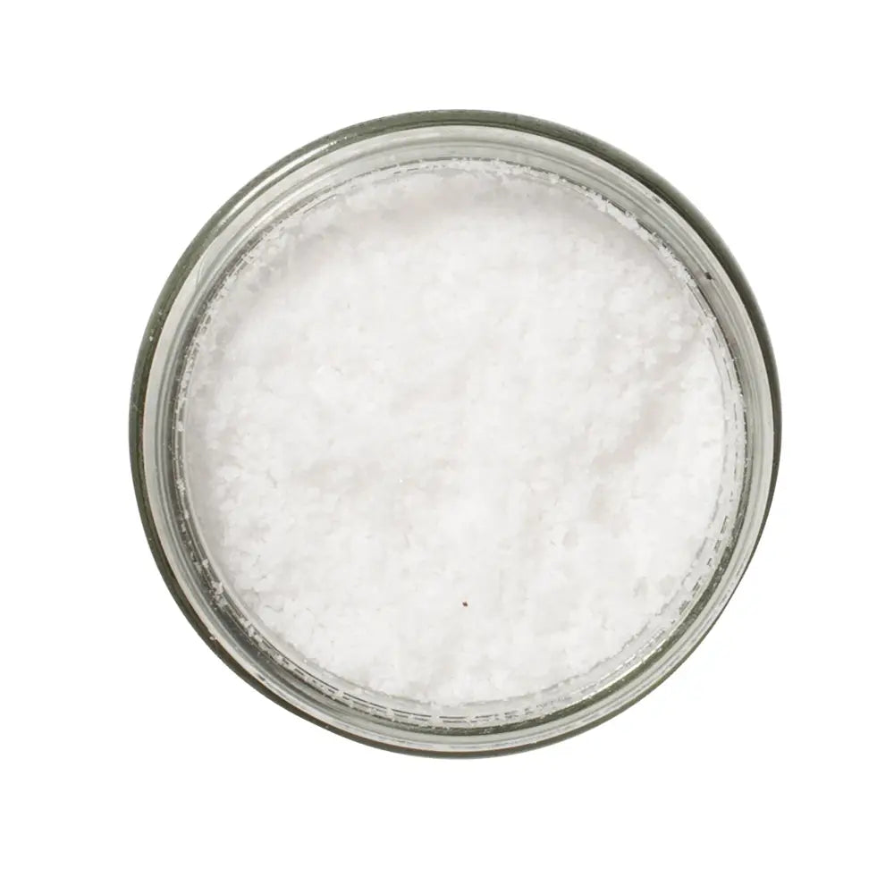 Glass jar filled with Sea Salt on a white background