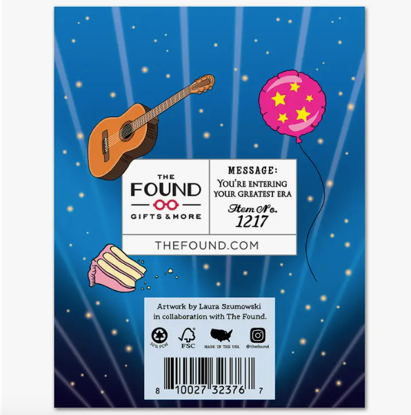 The back of the notecard. A blue background with a guitar, a pink ballon, and a slice of cake. Also includes The Found logo and a barcode.