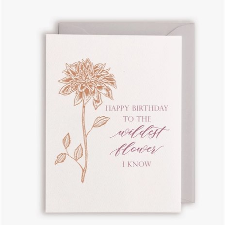 White card with red script text "Happy birthday to the wildest flower i know" with orange flower design