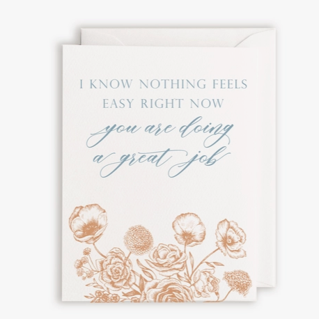White card with orange illustrated flowers on bottom and blue text saying "I know nothing feels easy right now, you are doing a great job"