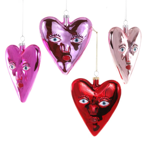 Heart-shaped ornaments with face designs in pink, red, and purple