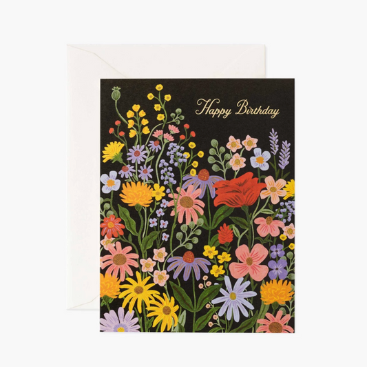 Black card with an illustration of colorful prairie flowers featuring gold text that says "Happy Birthday"