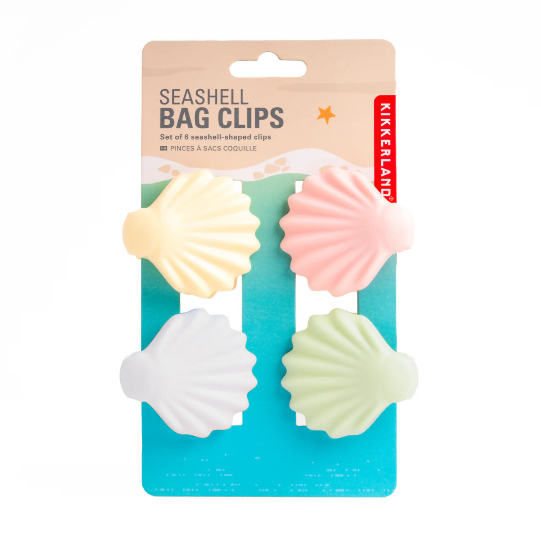 4 clamshell clips on their packaging card. Card is designed to look like the beach and says "Seashell Bag Clips"