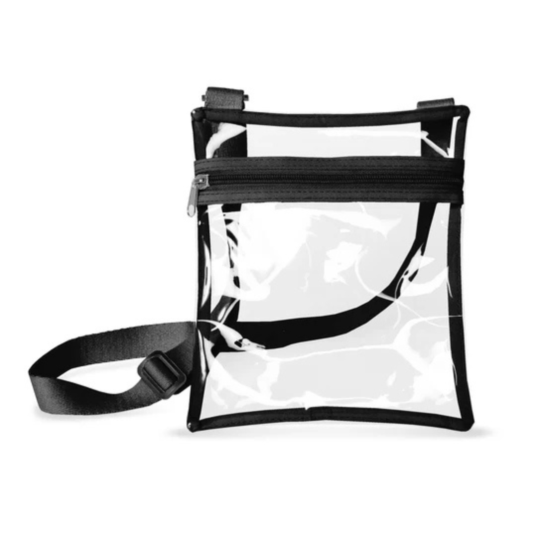 Rectangular clear vinyl bag with black trim. Bag has a black zipper at the top and an adjustable black strap