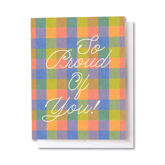 Greeting card with colorful checkered pattern and 'So Proud Of You!' text