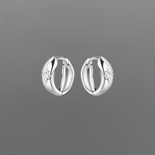 Pair of silver hoop earrings with star sparkle on a gray background