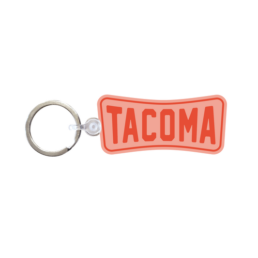 Pink keychain with 'Tacoma' text in orange.