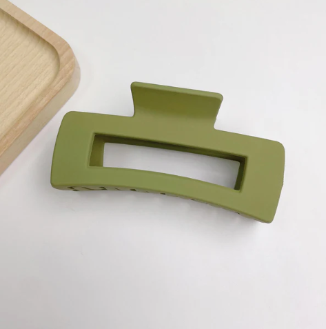 Olive Colored hair clip on a white background