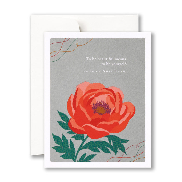 Beautiful red flower blooms against a gray background "To be beautiful means to be yourself. - Thich Nhat Hanh"