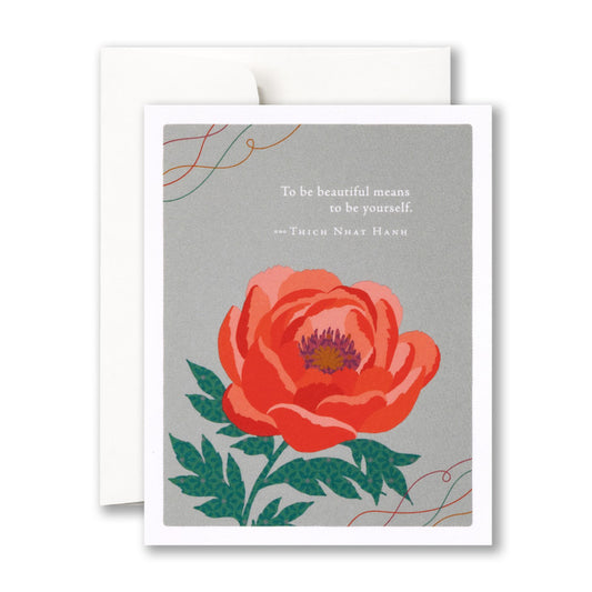 Beautiful red flower blooms against a gray background "To be beautiful means to be yourself. - Thich Nhat Hanh"