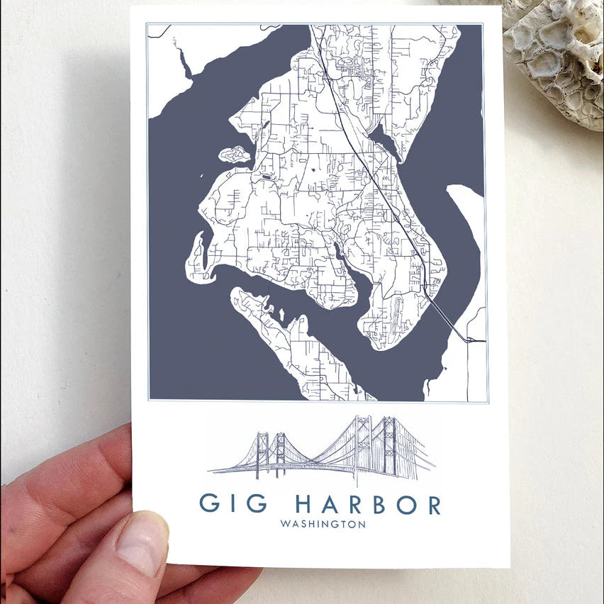 Map of Gig Harbor, Washington held by a hand on a light background